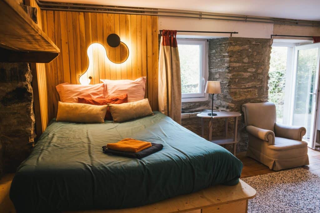 Studio Terrace, double bed against the stone wall